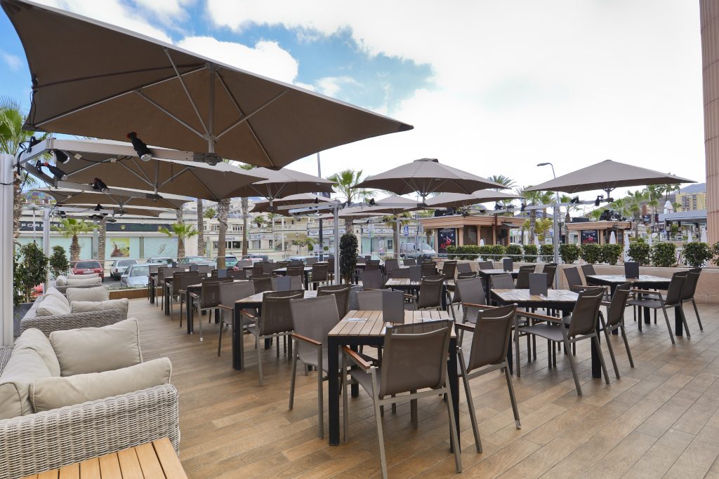 Terrace with tables and chairs under umbrellas in a restaurant in Tenerife.