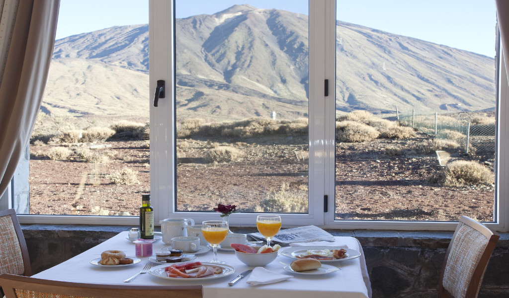 Breakfast served with a view of Mount Teide from a bay window in Tenerife.