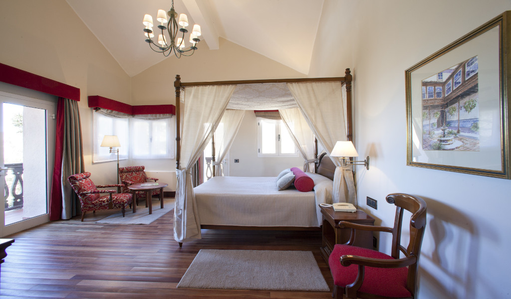 Room with four-poster bed, armchairs and balcony in Tenerife.