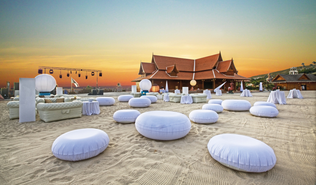 Comfortable white cushions on the beach at sunset at Siam Park Tenerife.