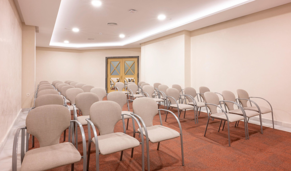 Empty conference room with rows of beige chairs in Tenerife.