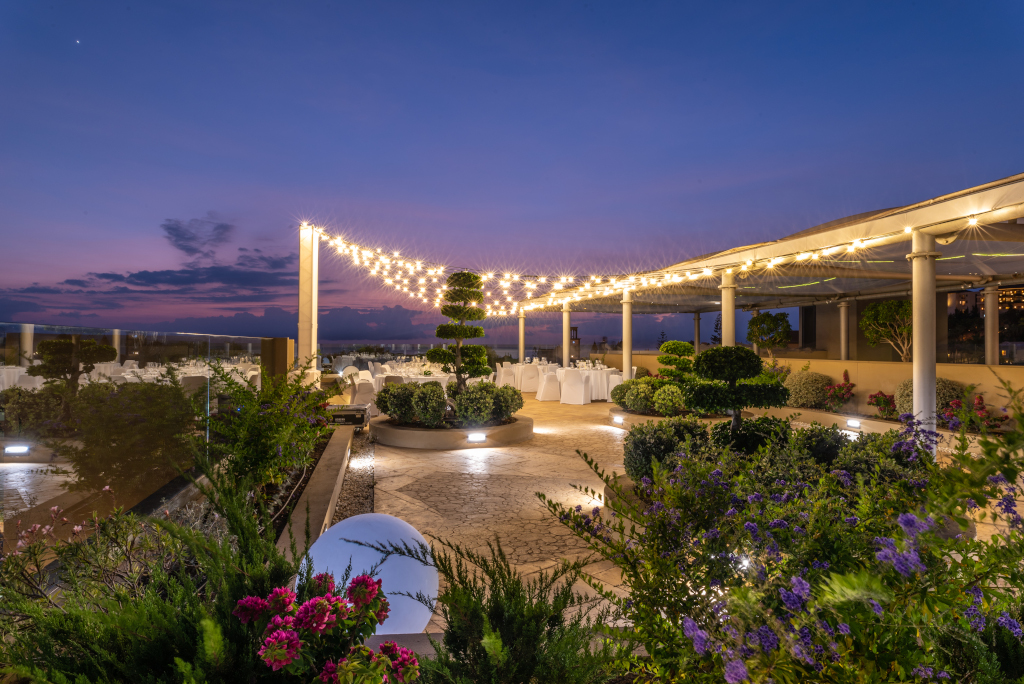 Terrace illuminated at dusk in Tenerife with tables prepared for events.