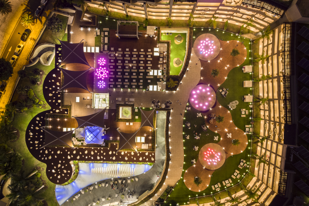 Night aerial view of illuminated terrace in Tenerife hotel.