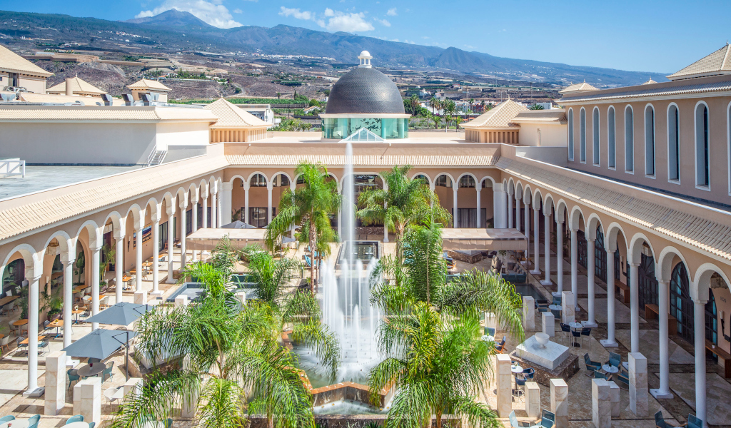 Courtyard with fountain and arches surrounded by mountains in Tenerife.