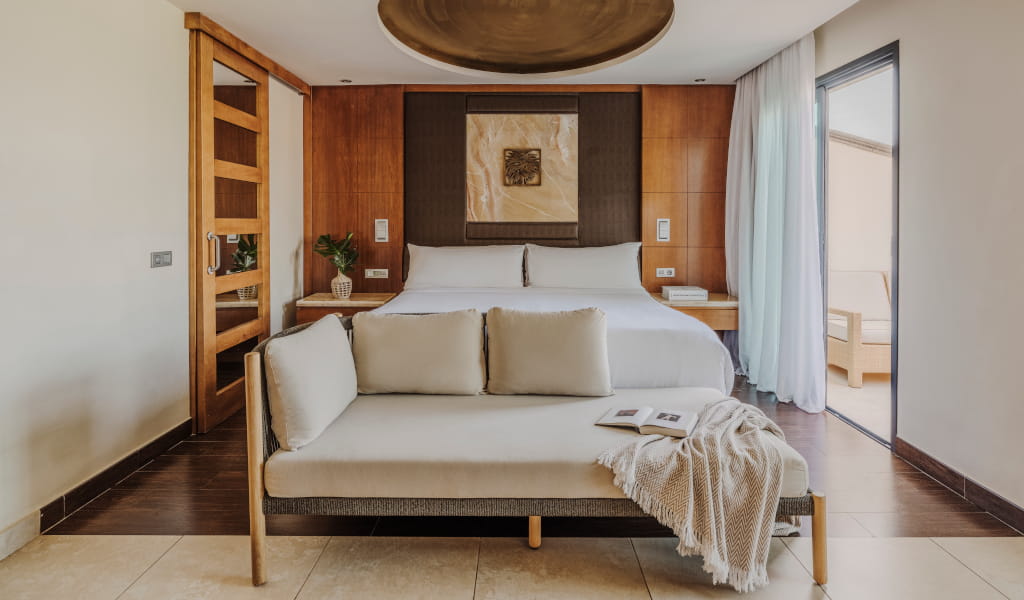 Room with double bed, sofa and decoration in neutral tones in Tenerife.