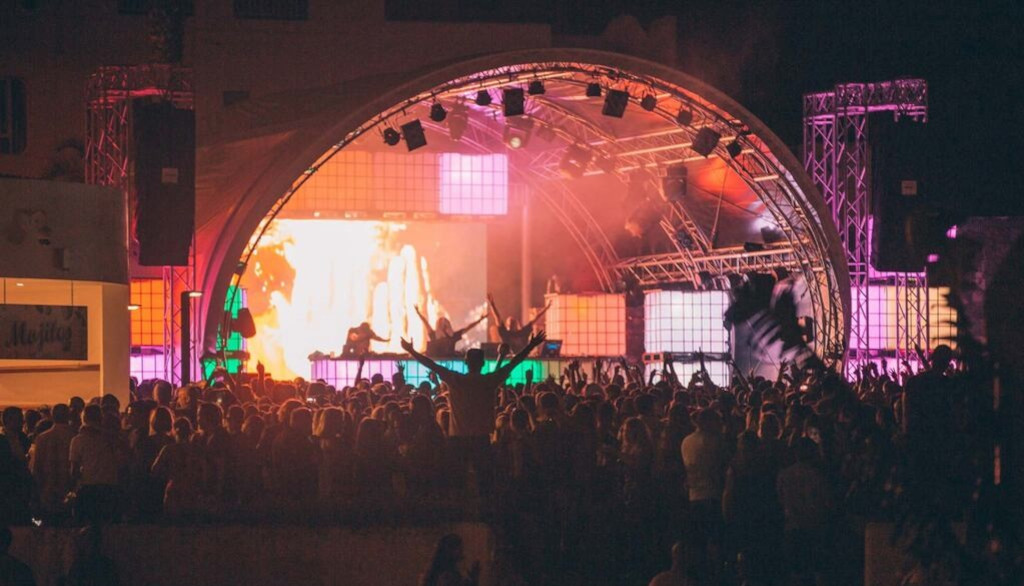 Night concert in Tenerife with a crowd in front of an illuminated stage.