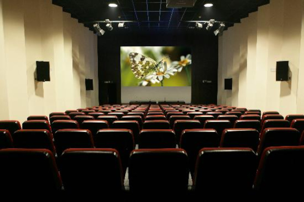 Empty cinema in Tenerife with butterfly image on screen.