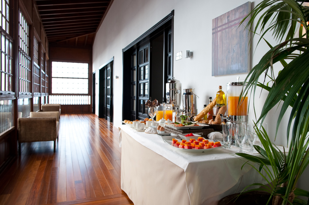 Breakfast buffet with juices and desserts in a bright room in Tenerife.