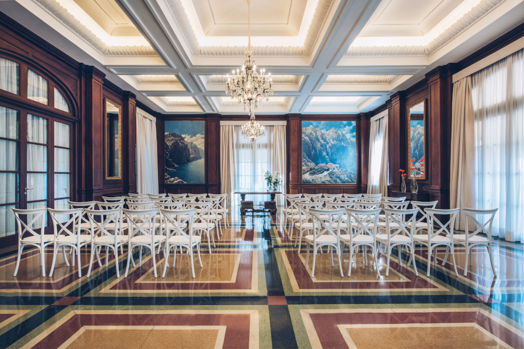 Event room with white chairs and landscape paintings in Tenerife.