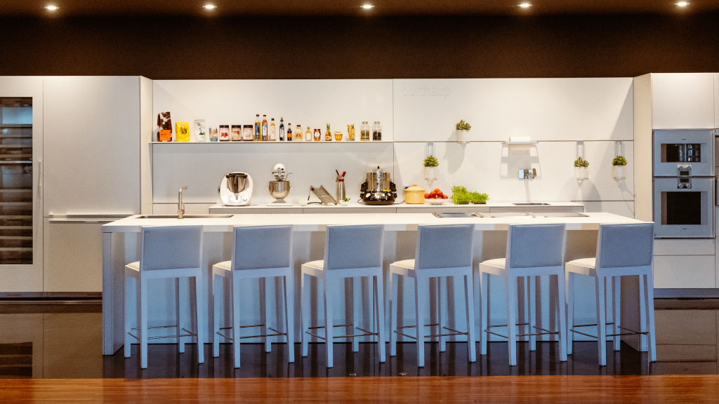 Modern kitchen with appliances and high chairs in Tenerife.
