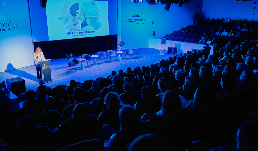 Auditorium in Tenerife with people attending a presentation on Parkinson's and Stigma.