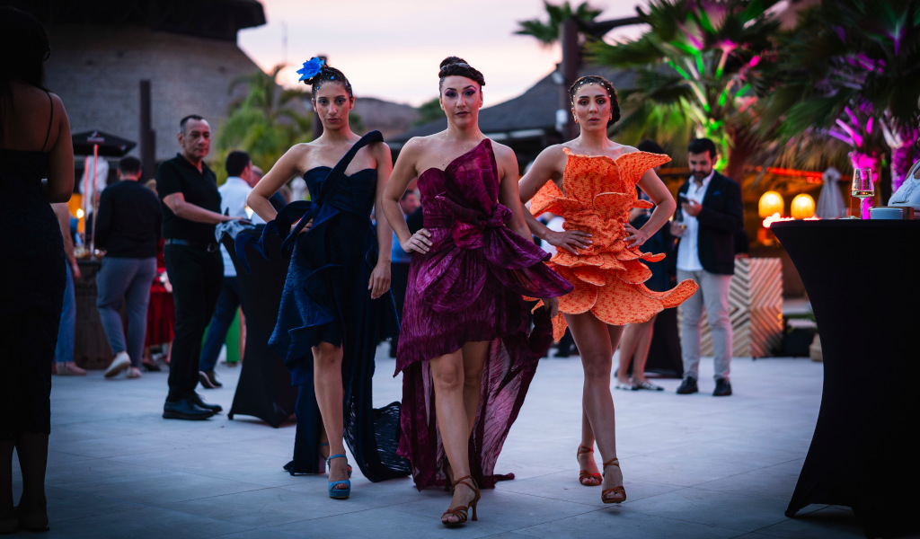 Models parading at an outdoor event in Tenerife at sunset.