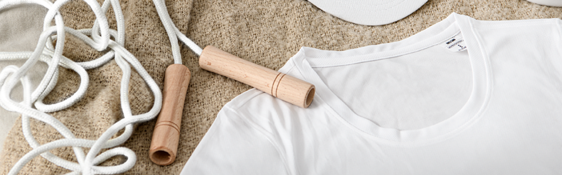 White t-shirt and jump rope in beige sweater.