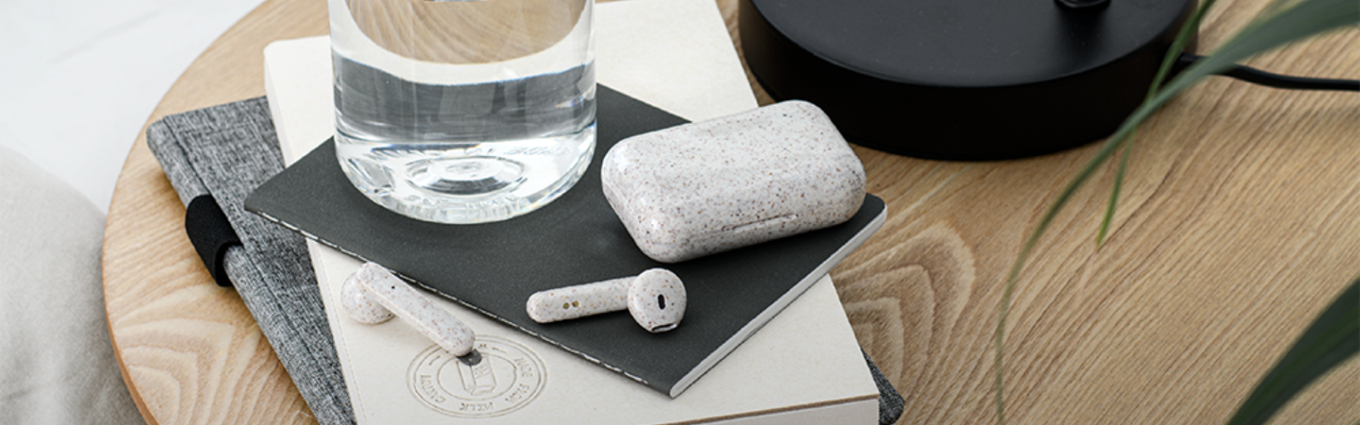 Headphones and case on a table with bottles and notebooks, in Santa Cruz de Tenerife.