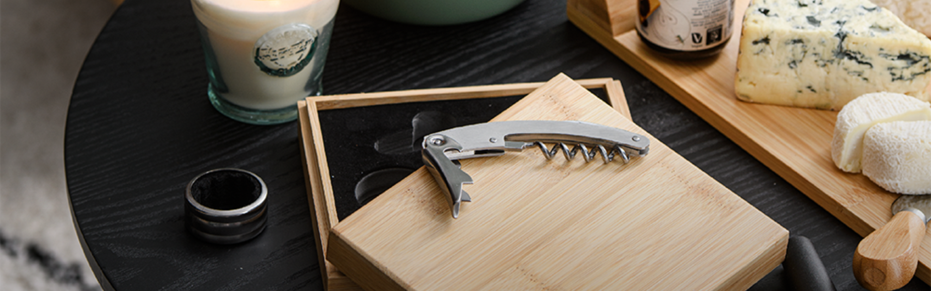 Corkscrew and cheese board on a black table in Tenerife.