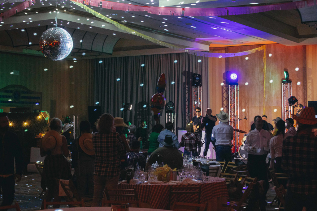 People enjoying a party with lights and a mirror ball in a living room in Tenerife.