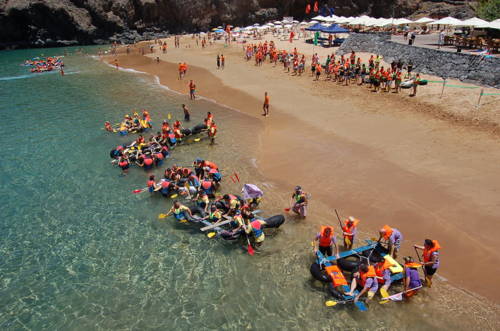 Groups preparing improvised boats on the beach of Tenerife.