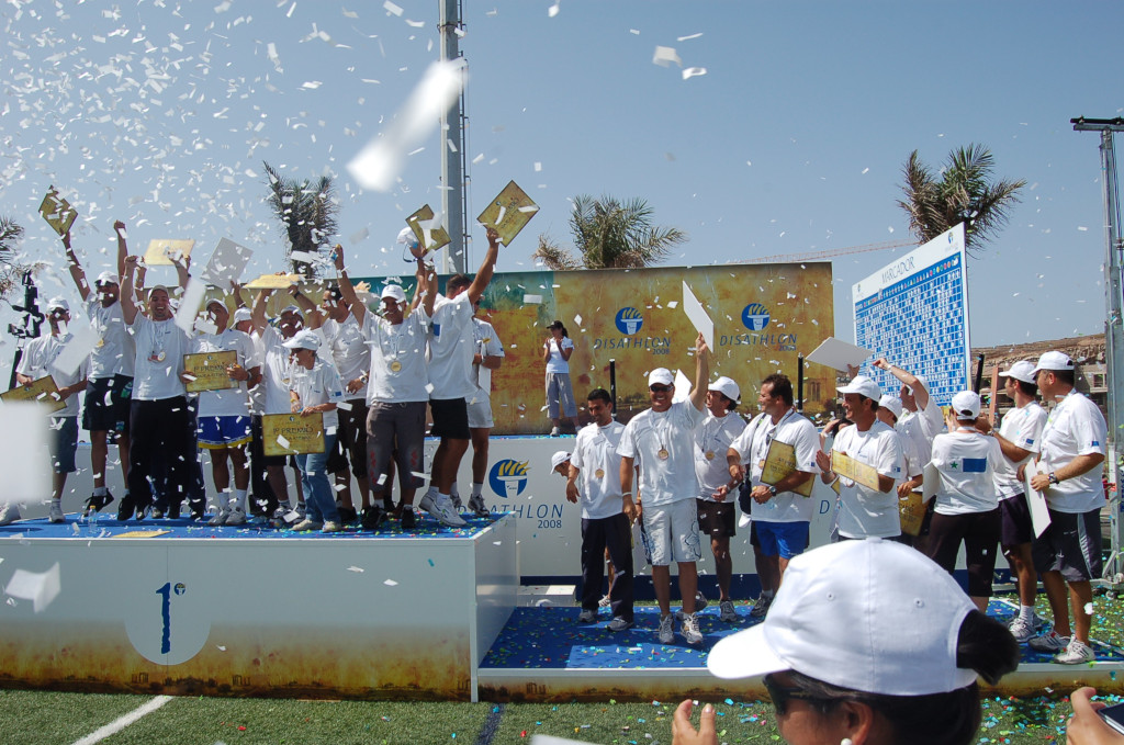Group of people celebrating on a podium with medals and diplomas in Tenerife.
