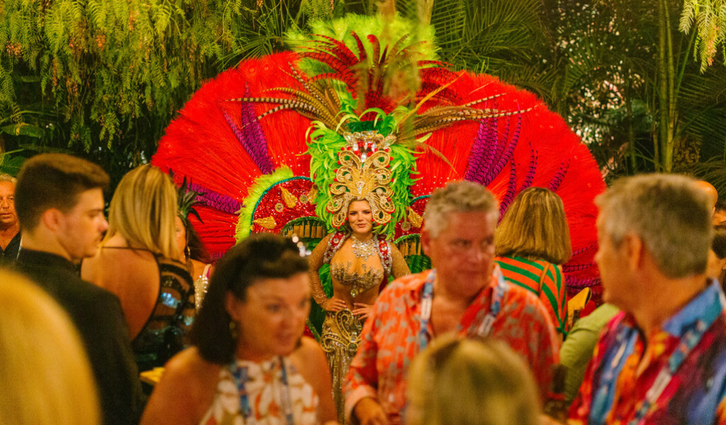 Person in a colorful carnival costume surrounded by people in Tenerife.