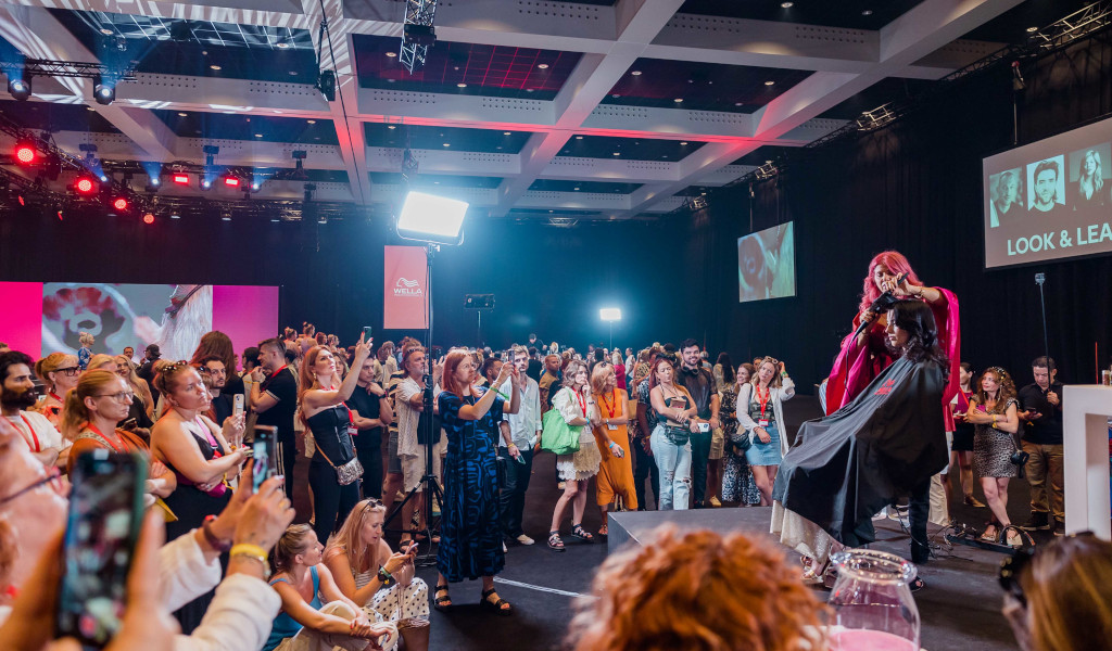 People watch a hairdressing demonstration at an event in Tenerife.
