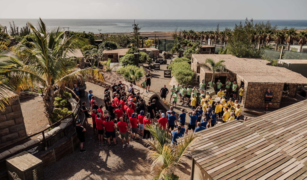 People gathered as a team under the sunlight by the sea in Tenerife.