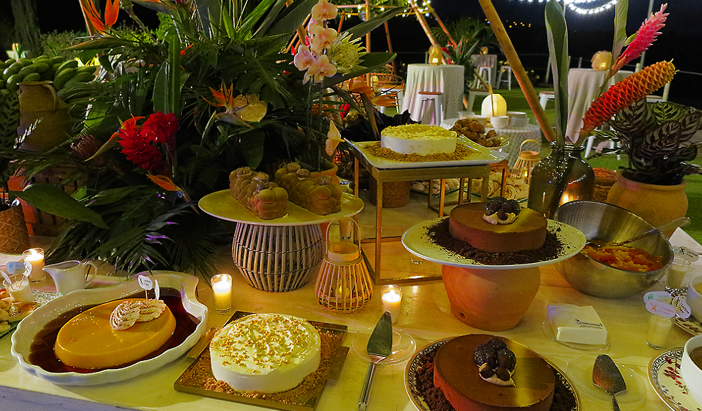 Assorted desserts on a table decorated with flowers in Tenerife.