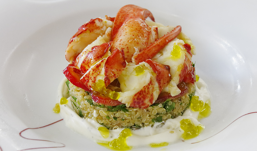 Lobster on a bed of quinoa with sauce, a speciality of Tenerife.