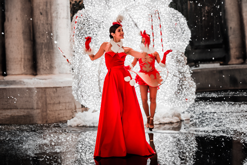 Person in red dress dancing near bright holiday decorations in Tenerife.