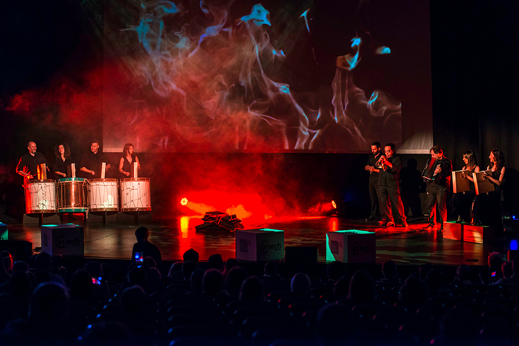 Musicians performing on stage with drums and wind instruments in Tenerife.