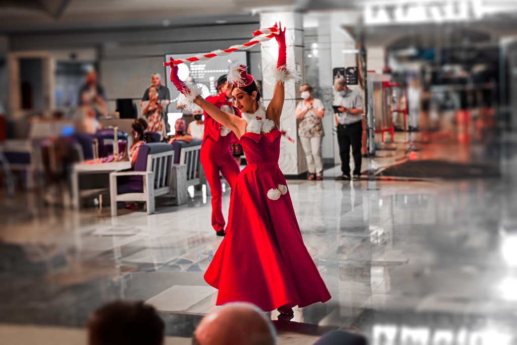 Performer in red dress dancing in a Tenerife restaurant.
