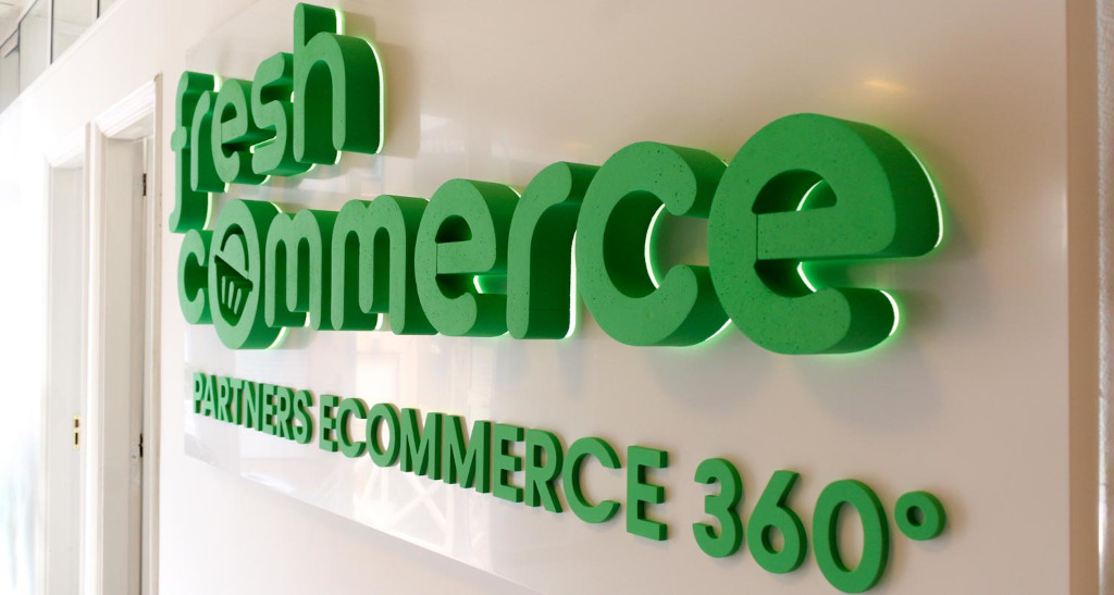 FreshCommerce Partners Ecommerce 360° green sign on wall.