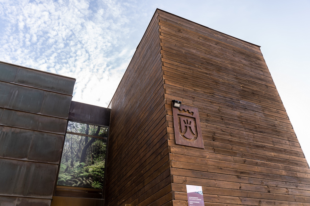 Wooden building exterior with emblem and sky view, located in Tenerife.