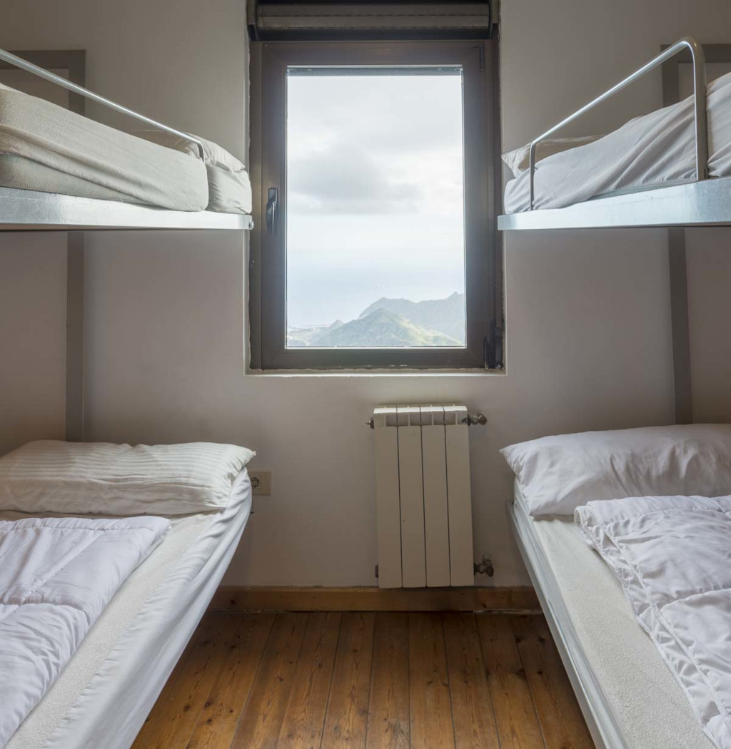Bunk beds in a room with a window view of Tenerife mountains.
