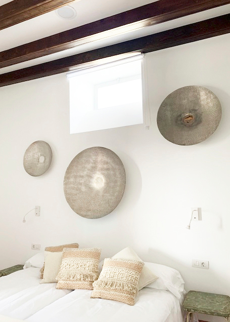 Decorative plates above bed in a Tenerife hotel room.
