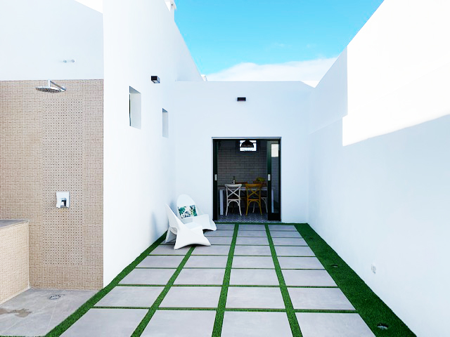 Outdoor patio area with white walls and chairs in Tenerife.