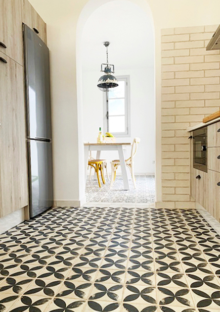 Kitchen with patterned floor tiles and view of dining table in Tenerife.