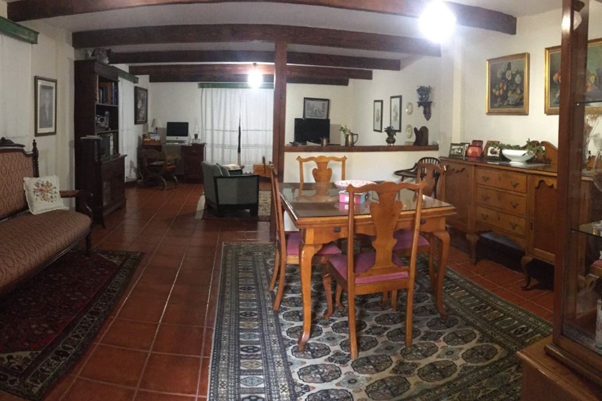 Dining and living room with wooden furniture in a Tenerife home.