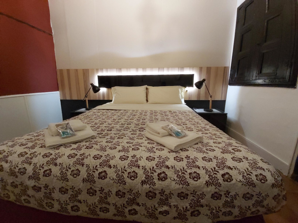 Cozy double bedroom with floral bedspread in La Laguna, Tenerife.