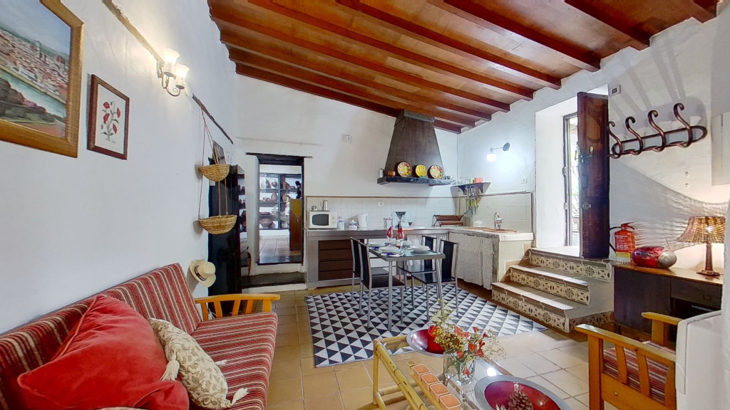 Cozy kitchen and living area with striped sofa and artwork in Tenerife home.