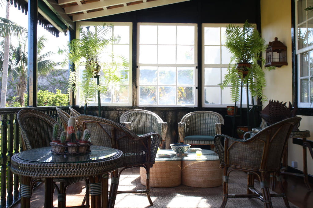 Wicker chairs and plants on a sunlit patio in a Tenerife home.