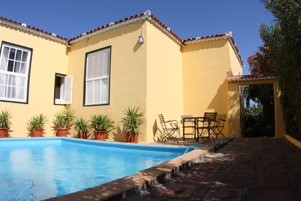 Courtyard with pool, potted plants, and outdoor seating at Tenerife villa.