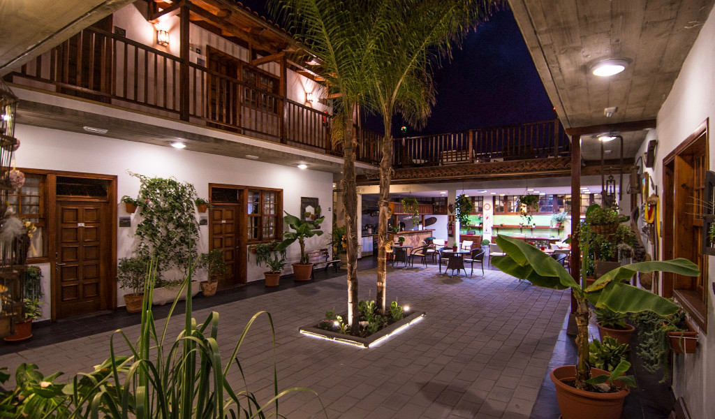 Nighttime view of a courtyard with plants and seating in Tenerife.