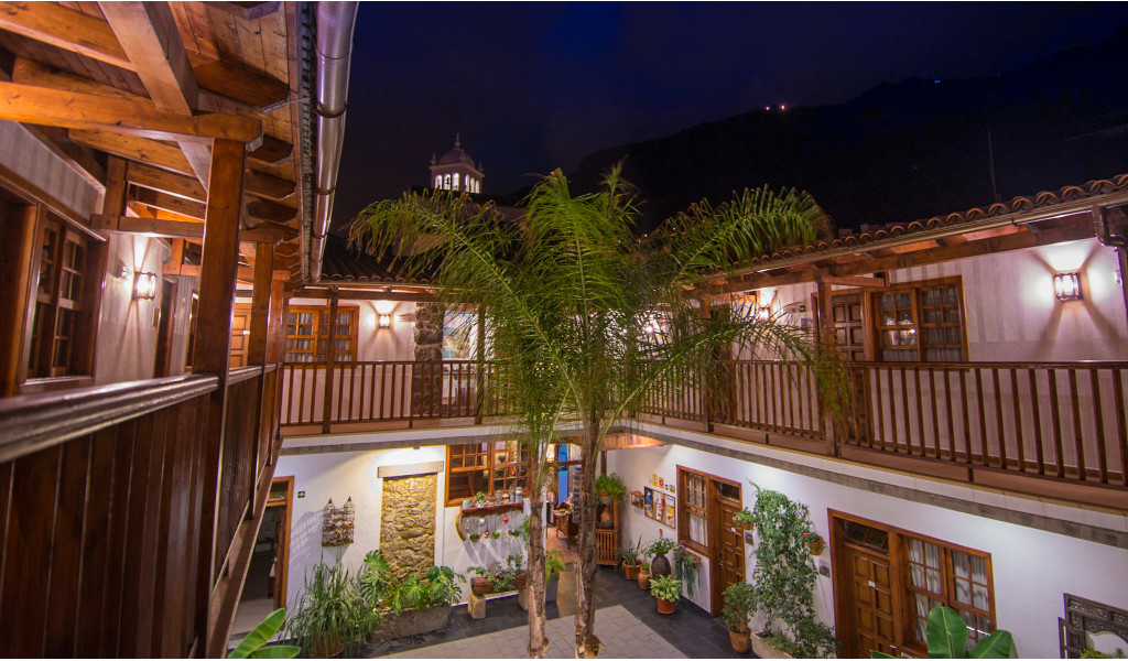 Courtyard with palm trees and balconies at night in La Orotava, Tenerife.