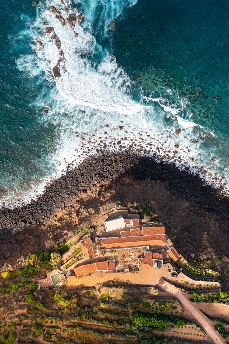 Aerial view of rocky coastline and buildings in Tenerife.