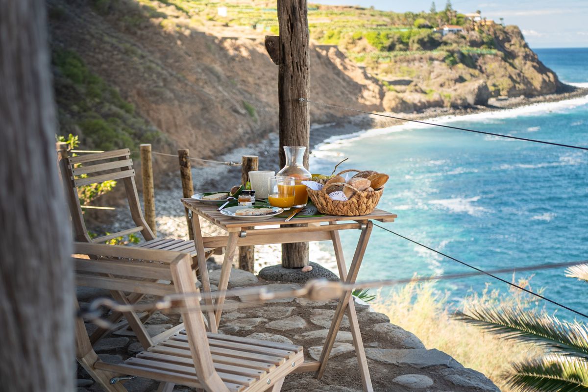 Breakfast table by the ocean at a cliffside in Tenerife.
