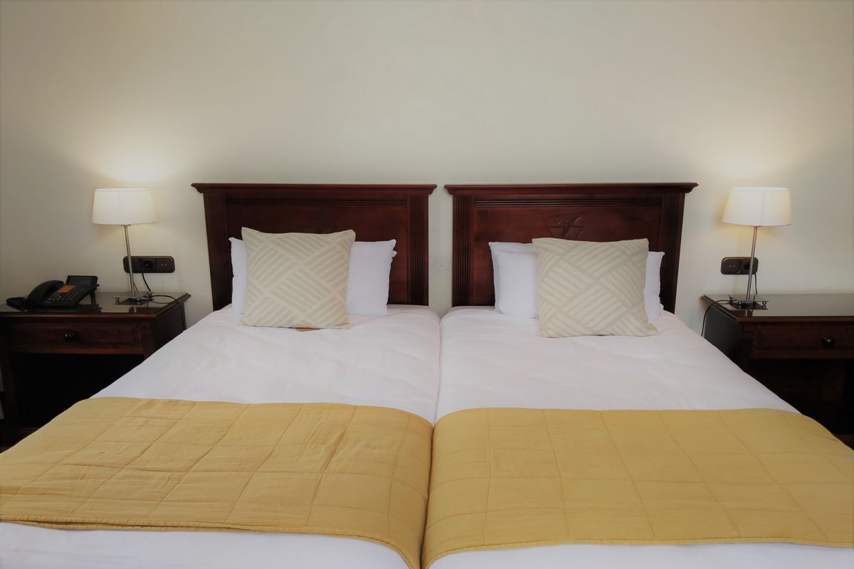 Two single beds with yellow covers in a Tenerife hotel room.