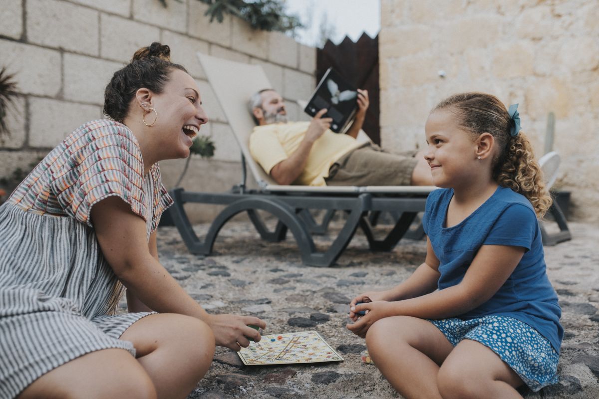 Family playing a board game on patio in Tenerife.