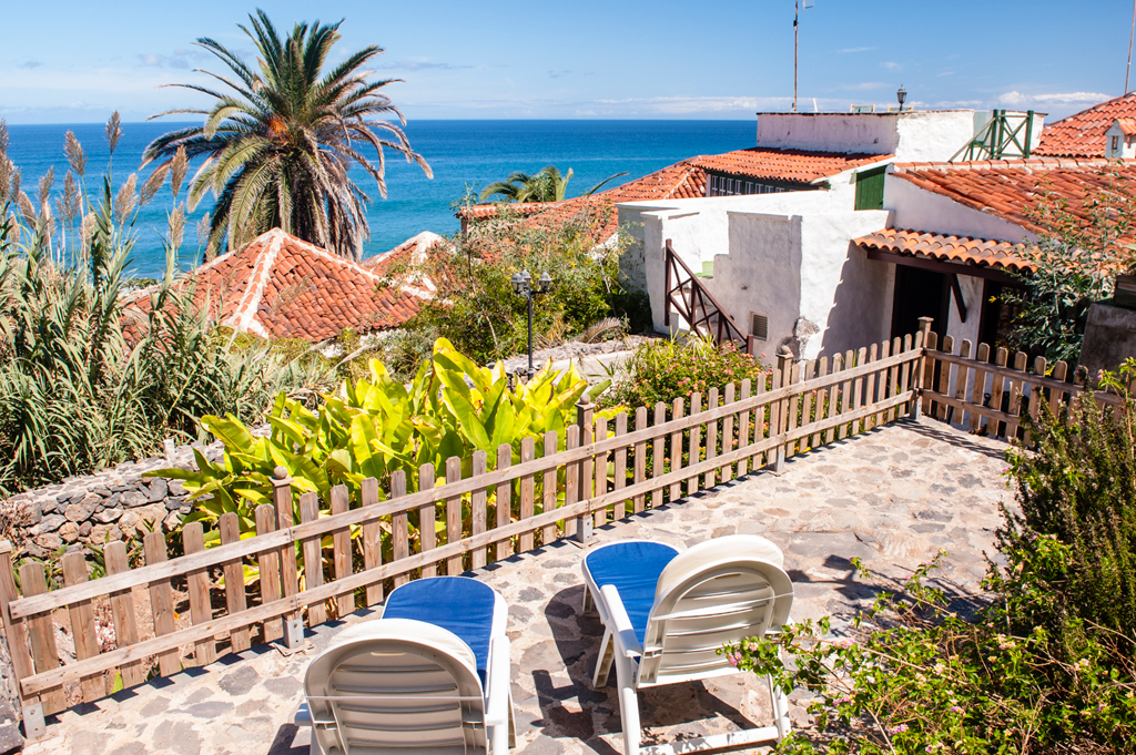 Two lounge chairs on a terrace overlooking the ocean in Tenerife.