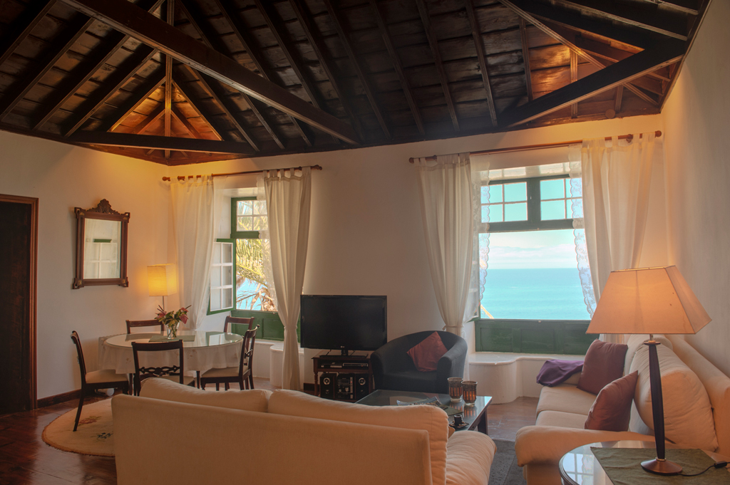 Cozy living room with ocean view in Tenerife cottage.