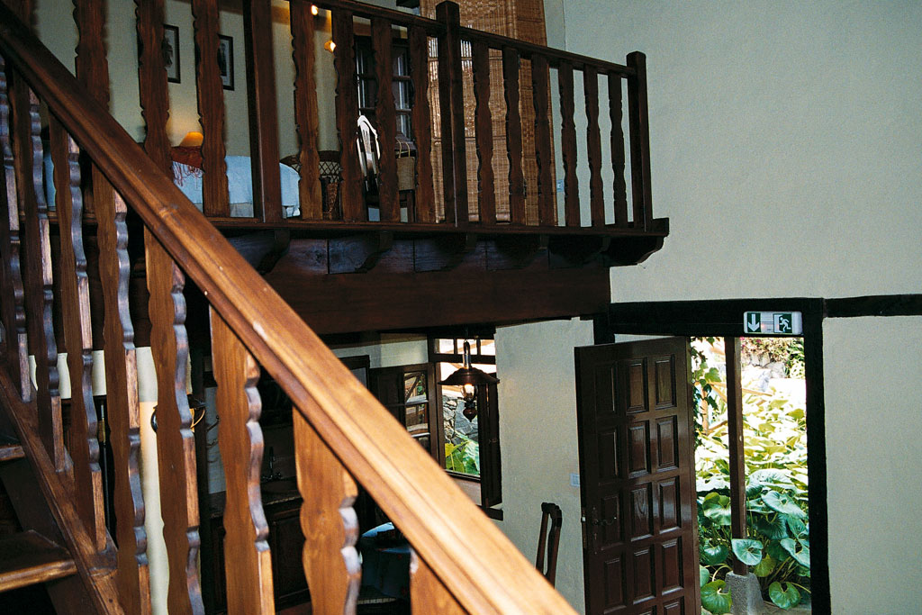 Staircase and open door with garden view in a house in Tenerife.